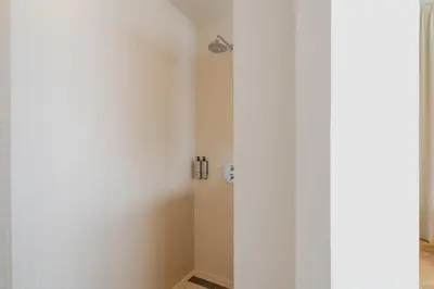 a bathroom with white walls and a shower at Hotel Pontsteiger in Amsterdam