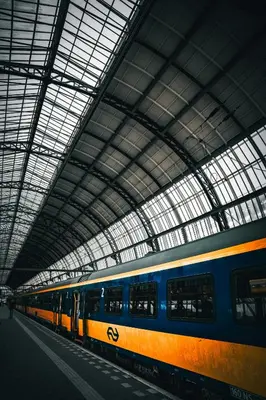a train is sitting in a train station at Hotel Pontsteiger in Amsterdam