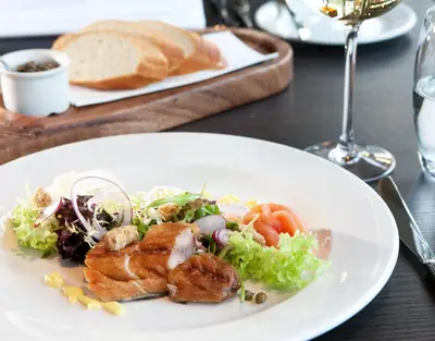 a white plate of food with a salad and bread at Fletcher Hotel-Restaurant Het Witte Huis in Amersfoort