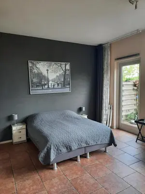 a bedroom with a bed and a black wall at Quarenta Studio in Amsterdam