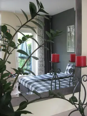 a bedroom with a bed and a mirror at Quarenta Studio in Amsterdam