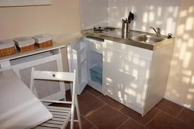 a small kitchen with a sink and a stove at Quarenta Studio in Amsterdam