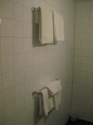 a bathroom with white towels hanging on a wall at Quarenta Studio in Amsterdam