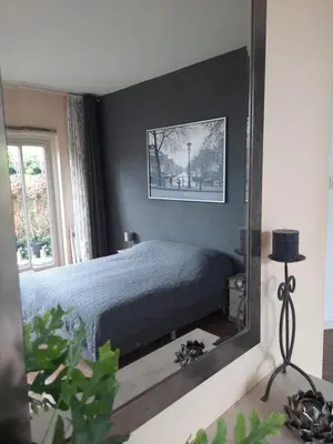 a bedroom with a bed and a mirror at Quarenta Studio in Amsterdam