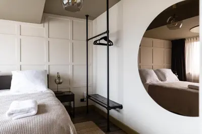 a bedroom with two beds and a mirror at Seabreeze Suites - near Zandvoort aan Zee in Overveen