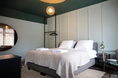 a bedroom with a bed with two towels on it at Seabreeze Suites - near Zandvoort aan Zee in Overveen