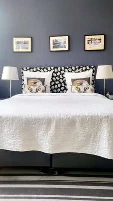 a bedroom with a bed with two cats heads on it at Velvetamsterdam in Amsterdam