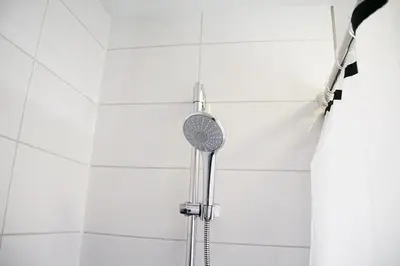 a shower with a shower head in a bathroom at Velvetamsterdam in Amsterdam