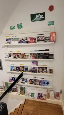 a wall with shelves filled with games at Velvetamsterdam in Amsterdam