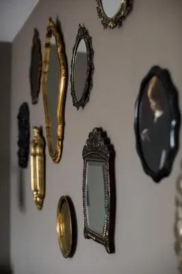 a group of mirrors hanging on a wall at B&B Habitat in Beverwijk