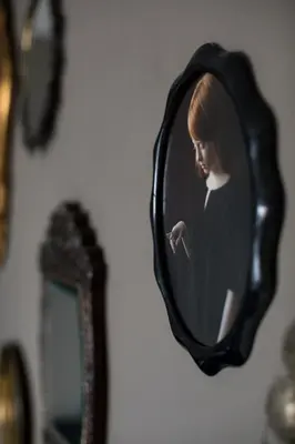 a picture of a woman in a mirror on a wall at B&B Habitat in Beverwijk
