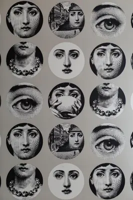 a collage of faces on a wall at B&B Habitat in Beverwijk