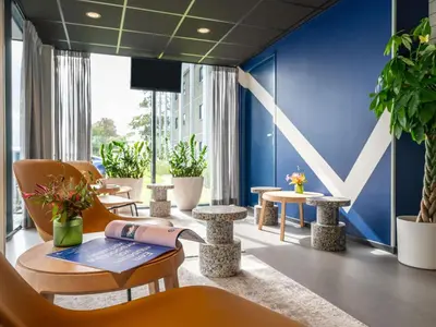 a room with a phone sitting on a table at ibis budget Amsterdam Airport in Badhoevedorp