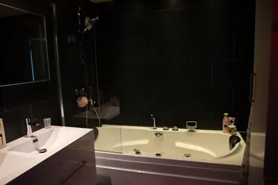 a bathroom with a bath tub and a sink at Jacuzzi Amsterdam Center Apartment Sunny Top Floor in Amsterdam