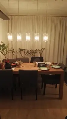 a dining room table with chairs and a wooden table with plates at Jacuzzi Amsterdam Center Apartment Sunny Top Floor in Amsterdam