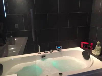 a bath tub filled with water in a bathroom at Jacuzzi Amsterdam Center Apartment Sunny Top Floor in Amsterdam