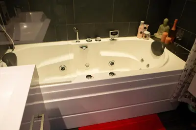 a white bath tub sitting in a bathroom at Jacuzzi Amsterdam Center Apartment Sunny Top Floor in Amsterdam
