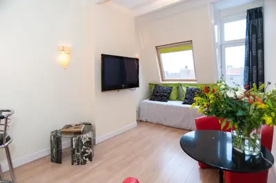 a living room with a couch and a tv at B&B Canaliscious in Amsterdam