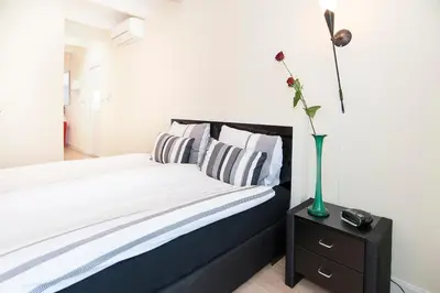 a bedroom with a bed and a vase with a flower at B&B Canaliscious in Amsterdam