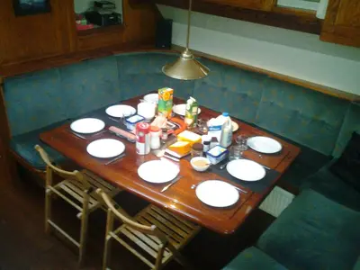 a wooden table with food on top of it at Tjalkjacht Pelikaan Volendam in Volendam