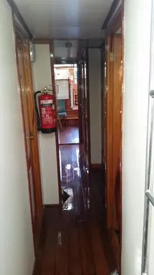 a hallway with a room with a fire extinguisher on the floor at Tjalkjacht Pelikaan Volendam in Volendam