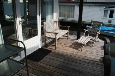 two chairs and a table on a porch at Houseboat Studio Sooki in Amsterdam