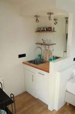 a kitchen with a sink and a counter at Houseboat Studio Sooki in Amsterdam
