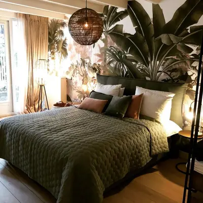 a bedroom with a bed with a large plant on the wall at Villa360 in Amsterdam