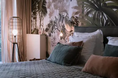 a bedroom with a bed with pillows and a plant wall at Villa360 in Amsterdam