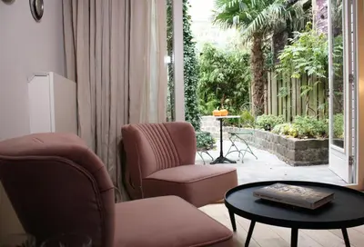 a living room with two chairs and a table at Villa360 in Amsterdam