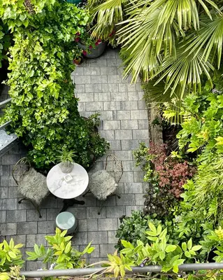 a patio with a table and some plants at Villa360 in Amsterdam