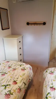 a bedroom with a bed and a dresser in it at Chalet in Castricum