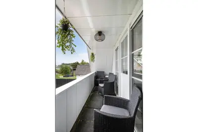 a balcony with black chairs and windows at Casa Grande - cityview Amsterdam in Landsmeer