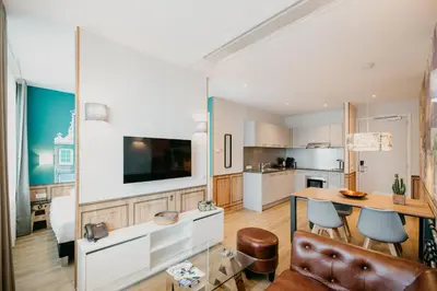 a kitchen and living room with a table and chairs at Amsterdam ID Aparthotel in Amsterdam