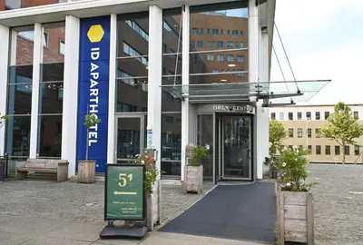 a building with a sign in front of it at Amsterdam ID Aparthotel in Amsterdam