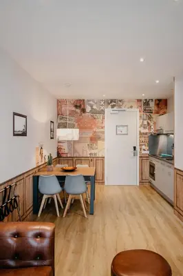 a kitchen and dining room with a table and chairs at Amsterdam ID Aparthotel in Amsterdam