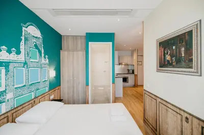 a bedroom with a bed and a painting on the wall at Amsterdam ID Aparthotel in Amsterdam