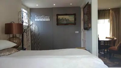 a bedroom with a bed and a sign on the wall at Rijnzicht in Alphen aan den Rijn