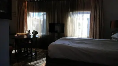 a bedroom with a bed and a table and a television at Rijnzicht in Alphen aan den Rijn
