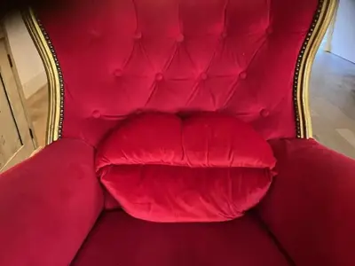 a red couch with a large red pillow on it at Bohemian loft in Amsterdam