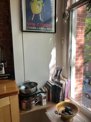 a window sill with a bowl of fruit on a counter at Bohemian loft in Amsterdam
