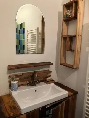 a bathroom with a white sink and a mirror at Bohemian loft in Amsterdam