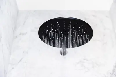a black comb hanging from a wall in a bathroom at Zandvoort Studio in Zandvoort