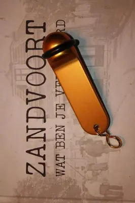 a yellow light hanging from a wall with a sign at Zandvoort Studio in Zandvoort