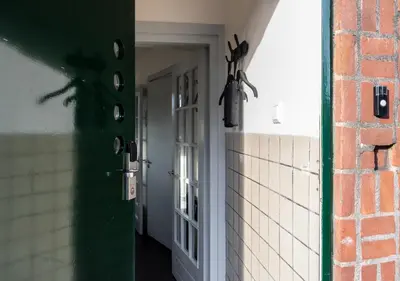 an open door with a lizard hanging on a wall at SWEETS - Overtoomsesluis in Amsterdam