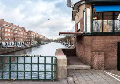 a view of a river with buildings and a building at SWEETS - Overtoomsesluis in Amsterdam