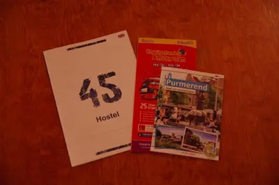 two magazines and a paper with the number on it at Hostel 45 in Purmerend