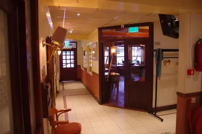 a hallway of a restaurant with a door leading to a dining room at Hostel 45 in Purmerend