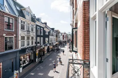a city street with people walking down the street at Cozy Pillow in Utrecht