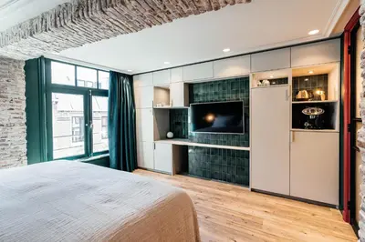a bedroom with a bed and a tv in a room at Cozy Pillow in Utrecht